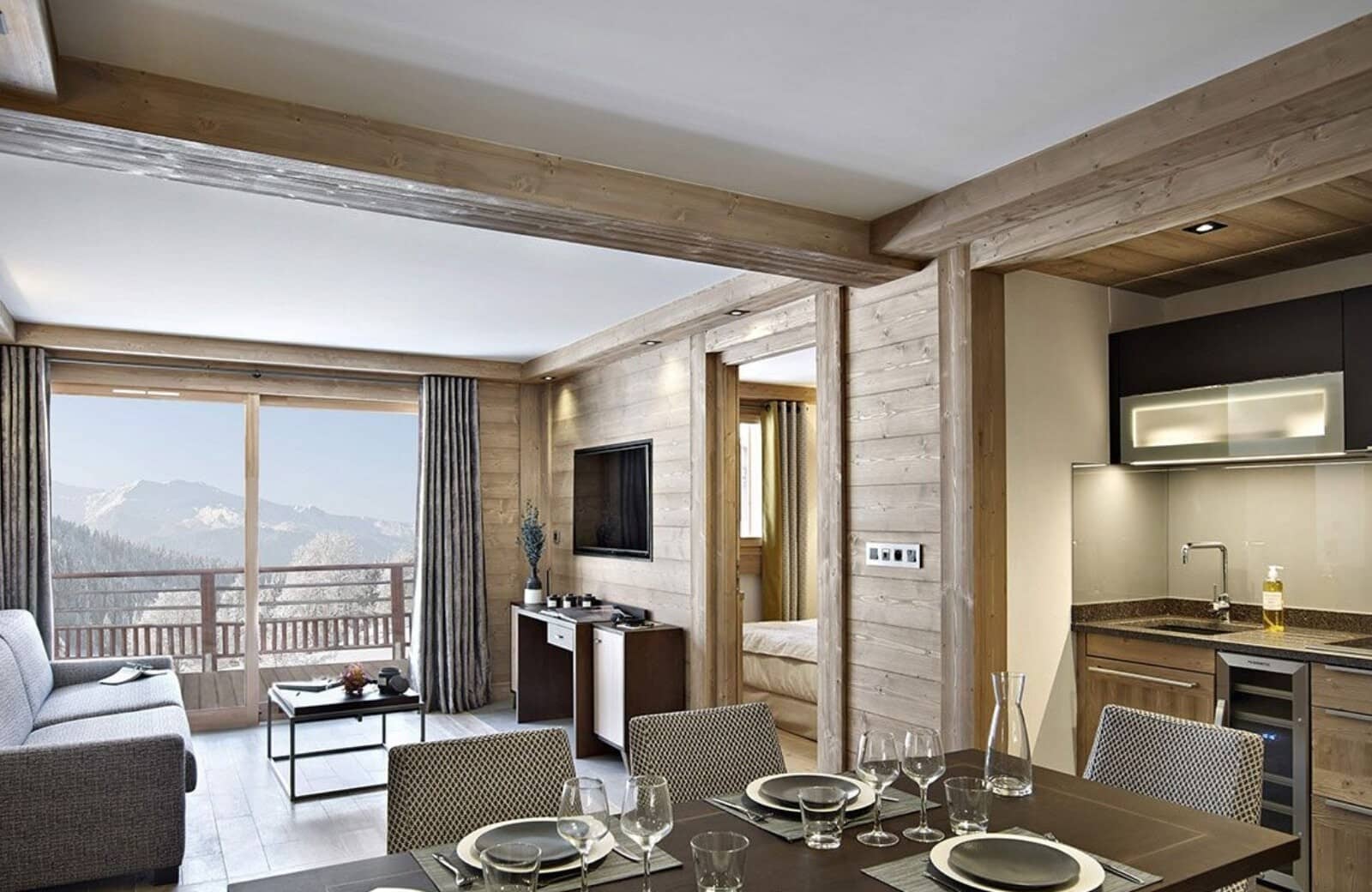 Open-plan suite with private balcony, mountain views, and kitchenette