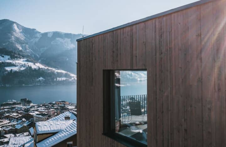Wood-clad exterior with panoramic lake and mountain views