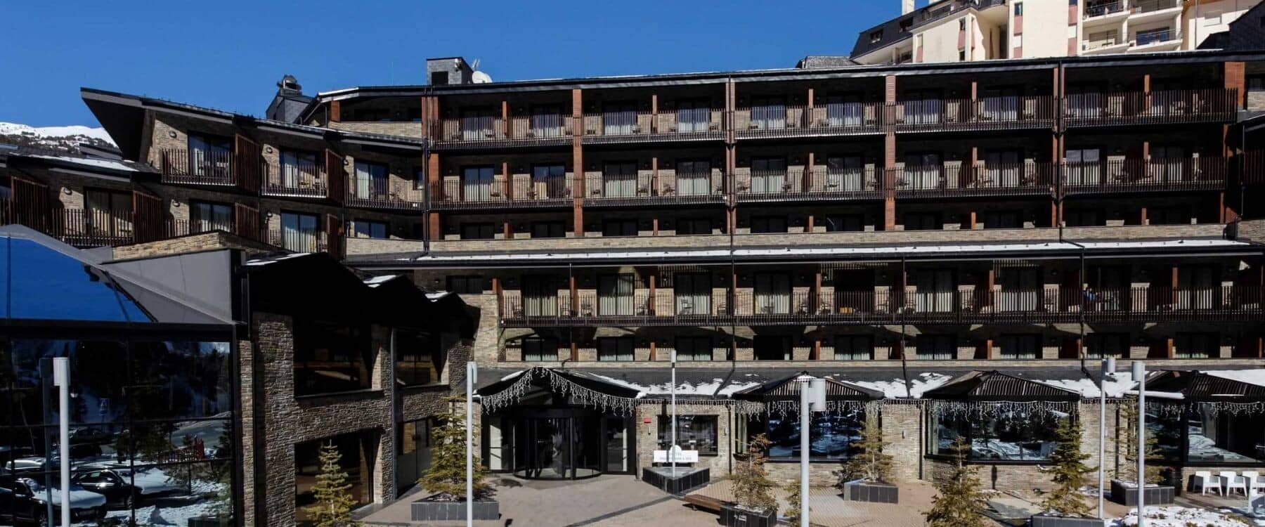Multi-story lodge exterior with private balconies and stone facade