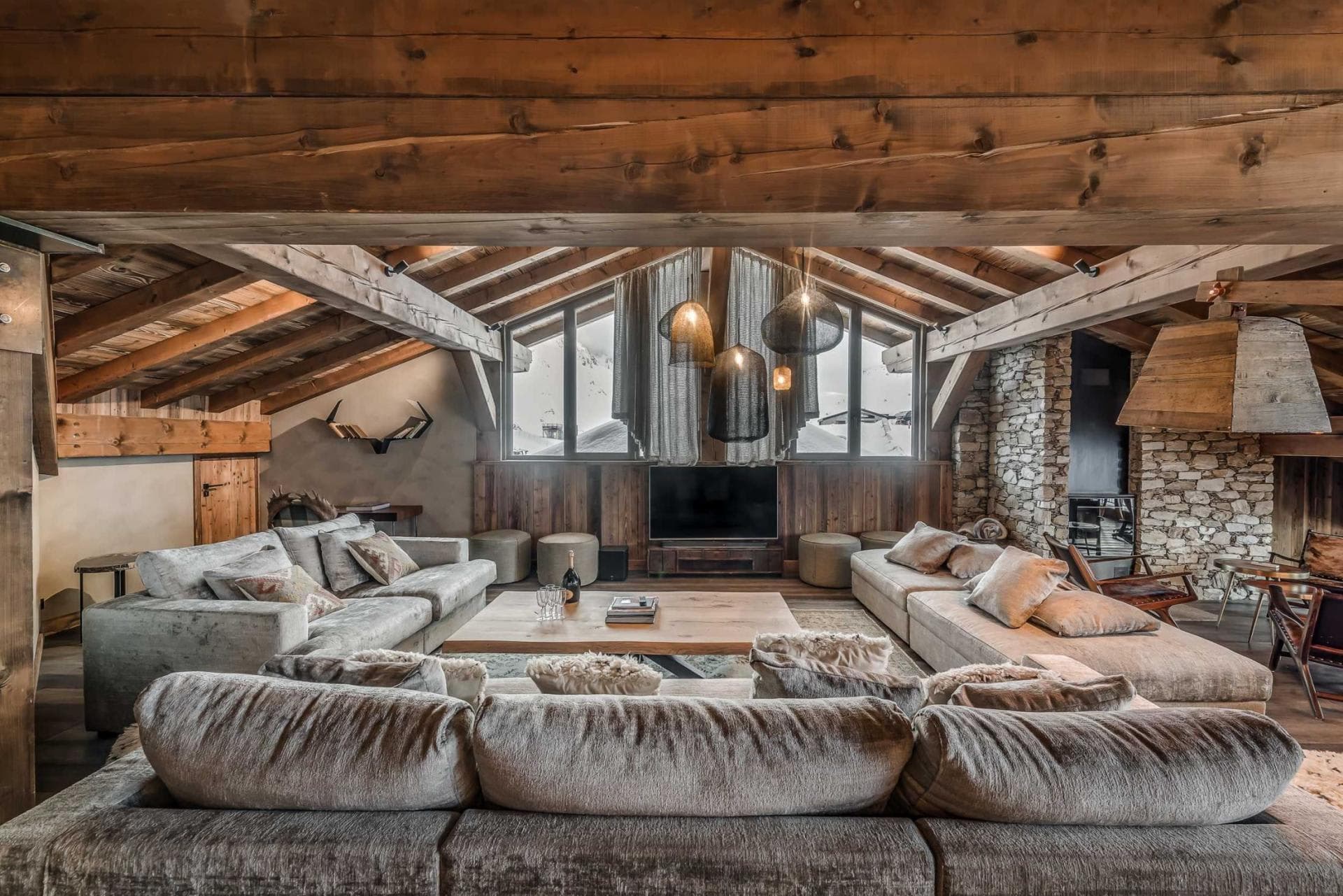 Living area with oversized sectional seating and stone fireplace