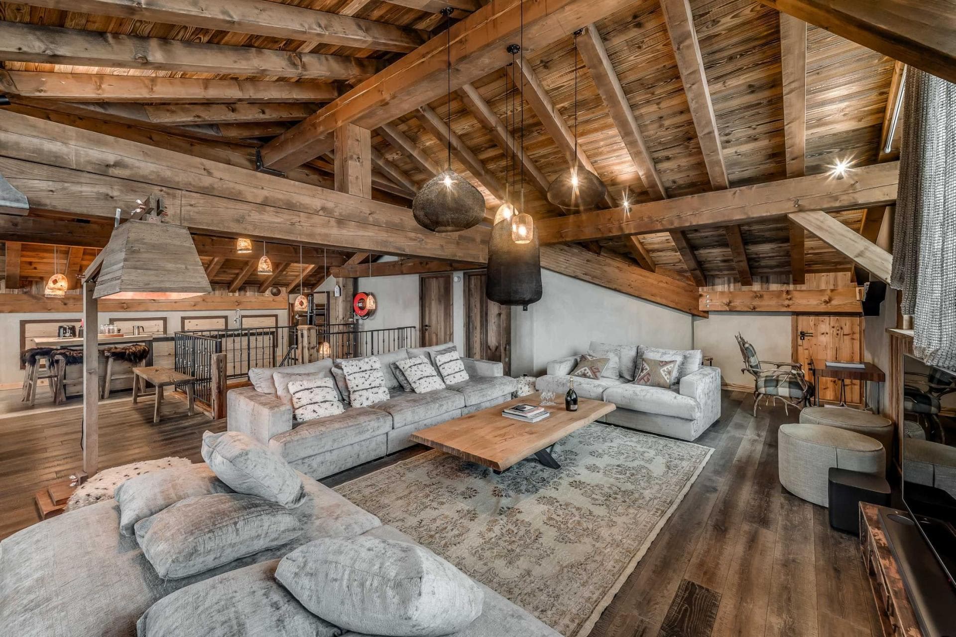 Loft living area with timber vaulted ceilings and sectional seating for 10