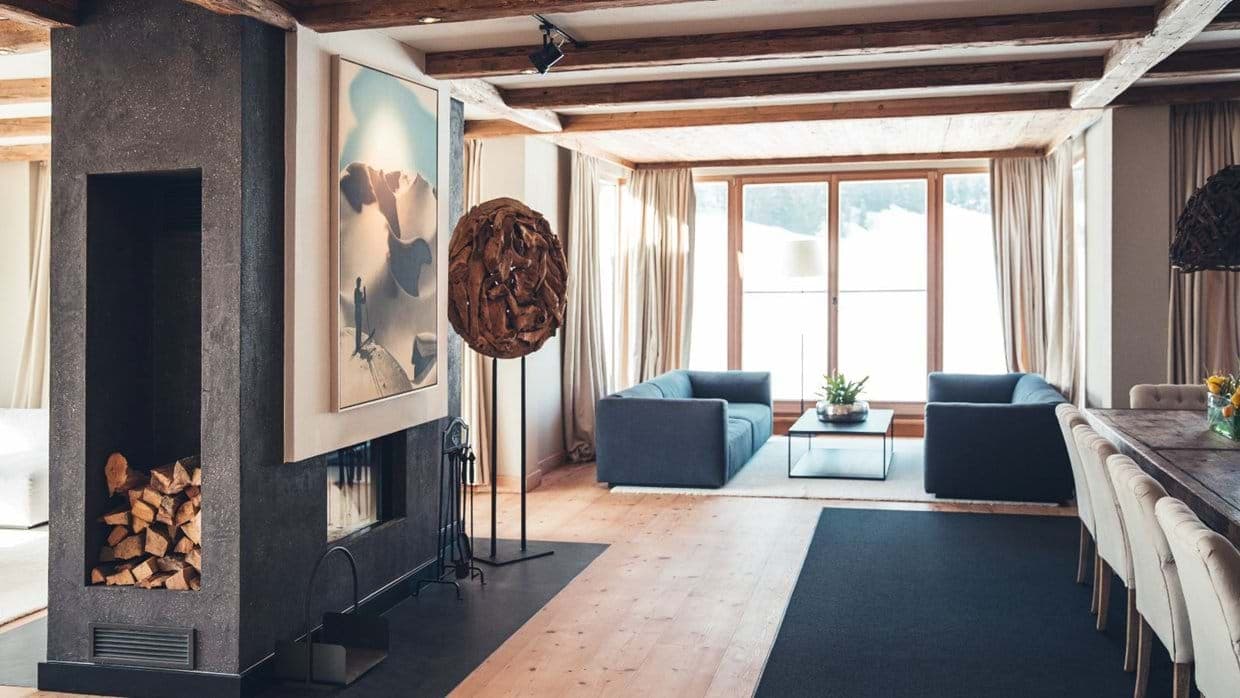 Living and dining area with wood-burning fireplace and mountain views