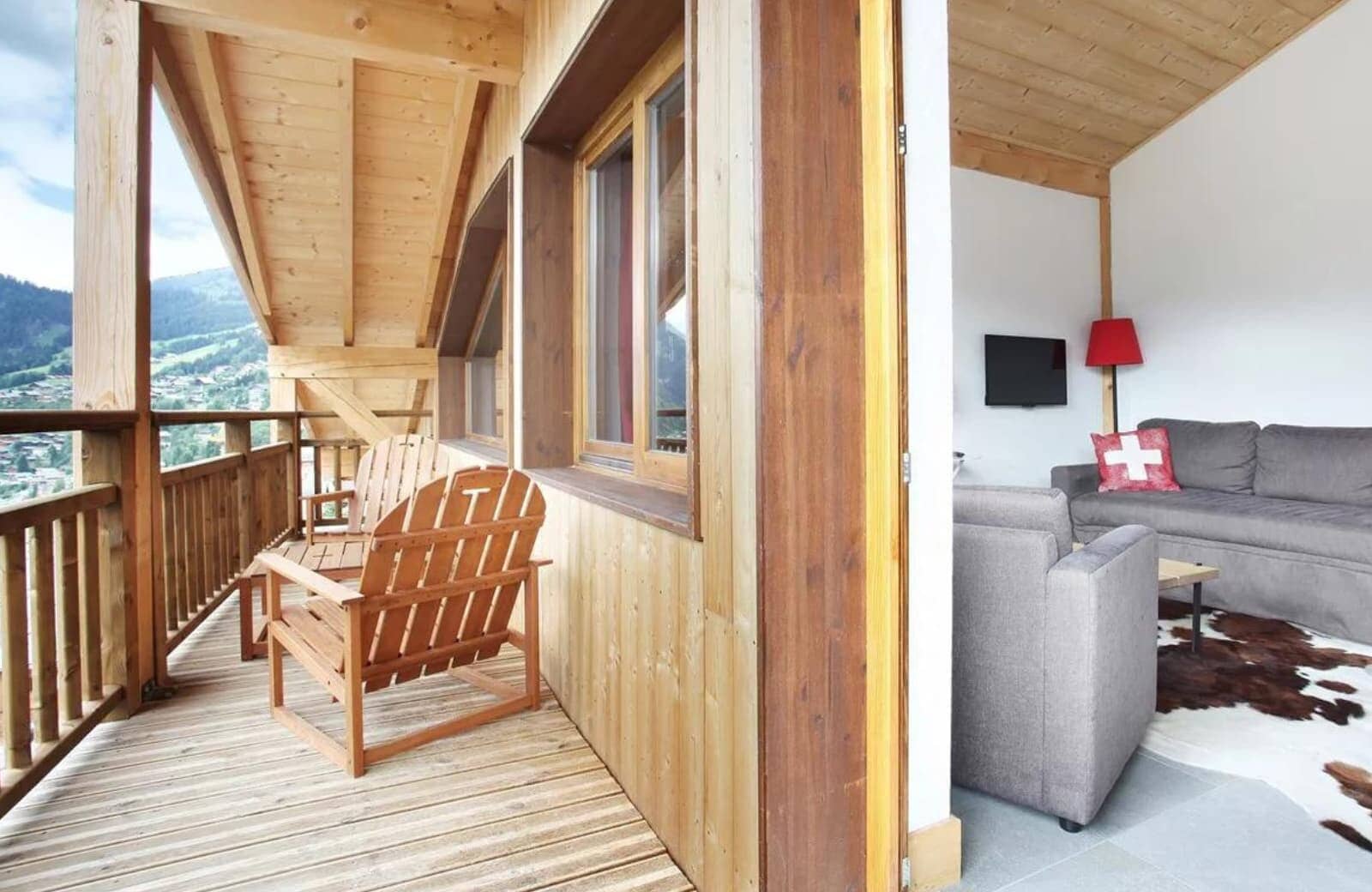 Covered balcony with Adirondack seating and valley views