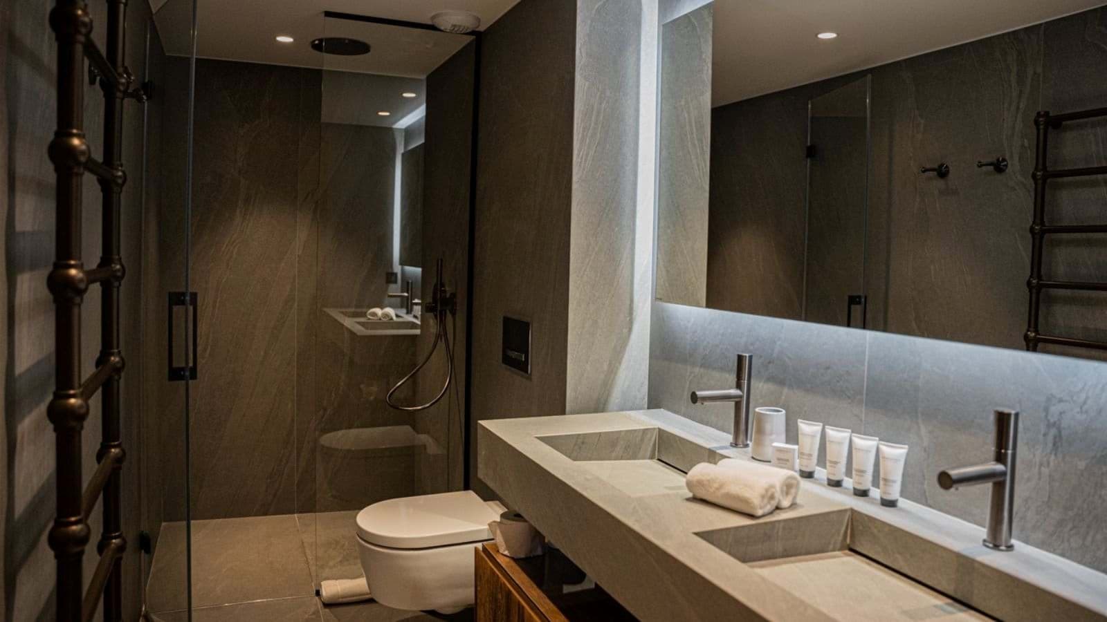 Bathroom with dual integrated sinks and walk-in rain shower