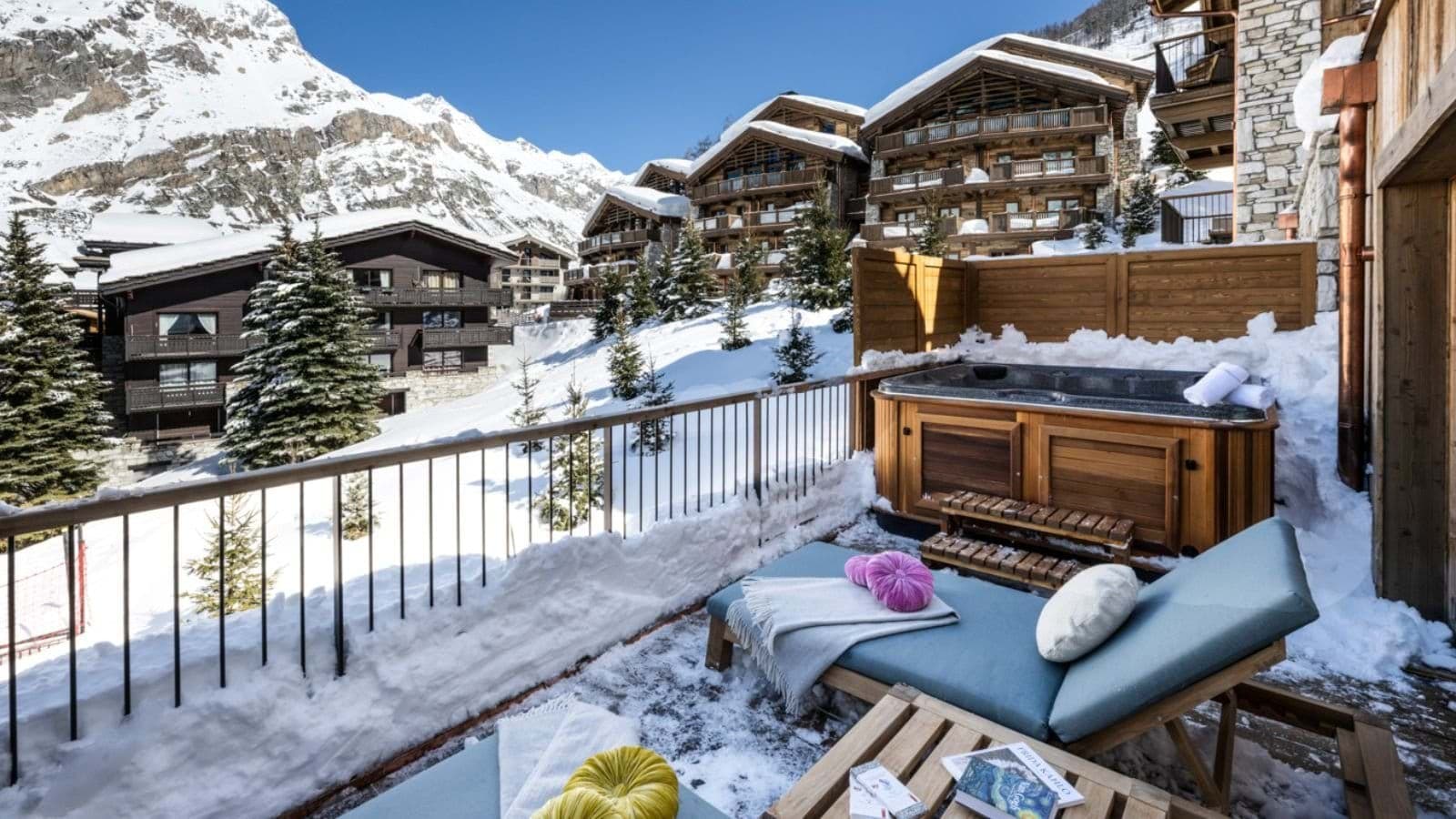 Private balcony with hot tub, sun loungers, and mountain views