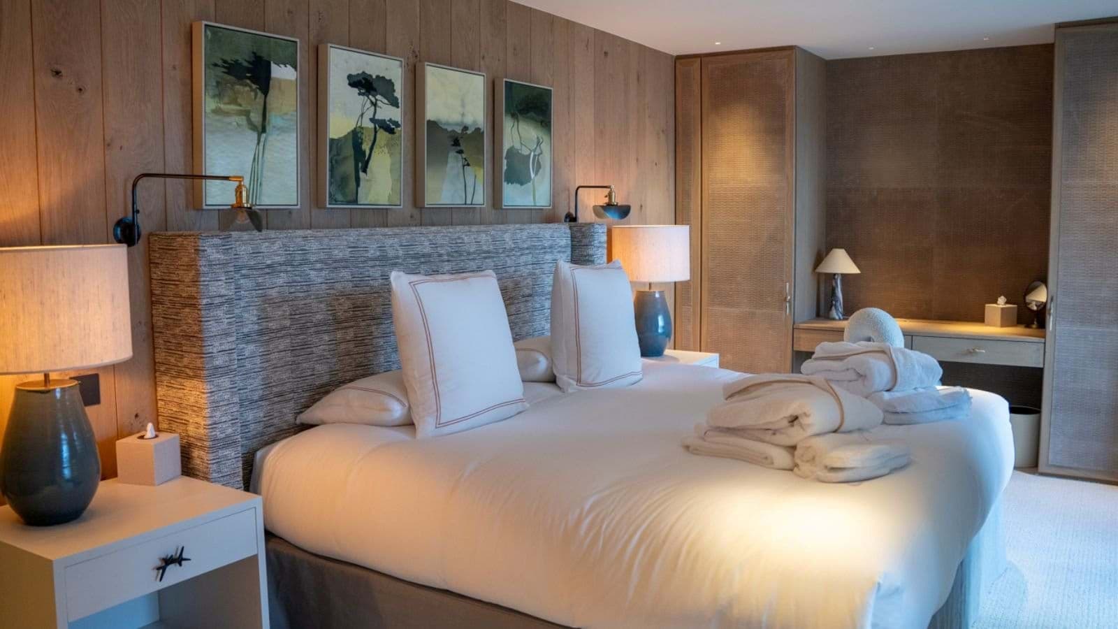 Primary bedroom with king bed, built-in wardrobes, and dedicated vanity desk