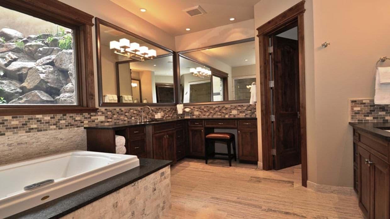 Bathroom with soaking tub and vanity featuring dedicated makeup station