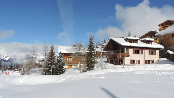 Chalet exterior with direct ski-in/ski-out access and mountain views