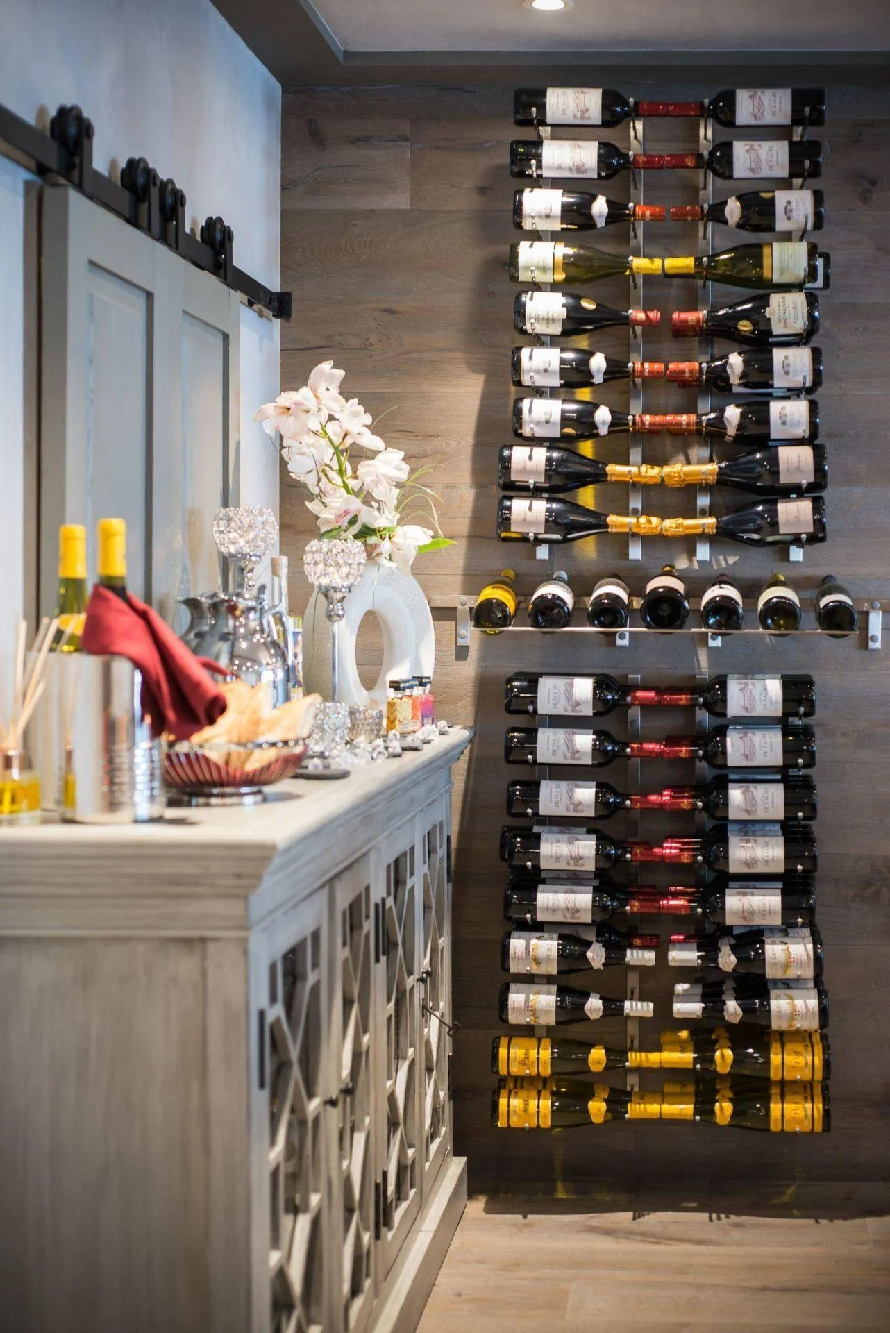 Floor-to-ceiling wine storage beside a sideboard