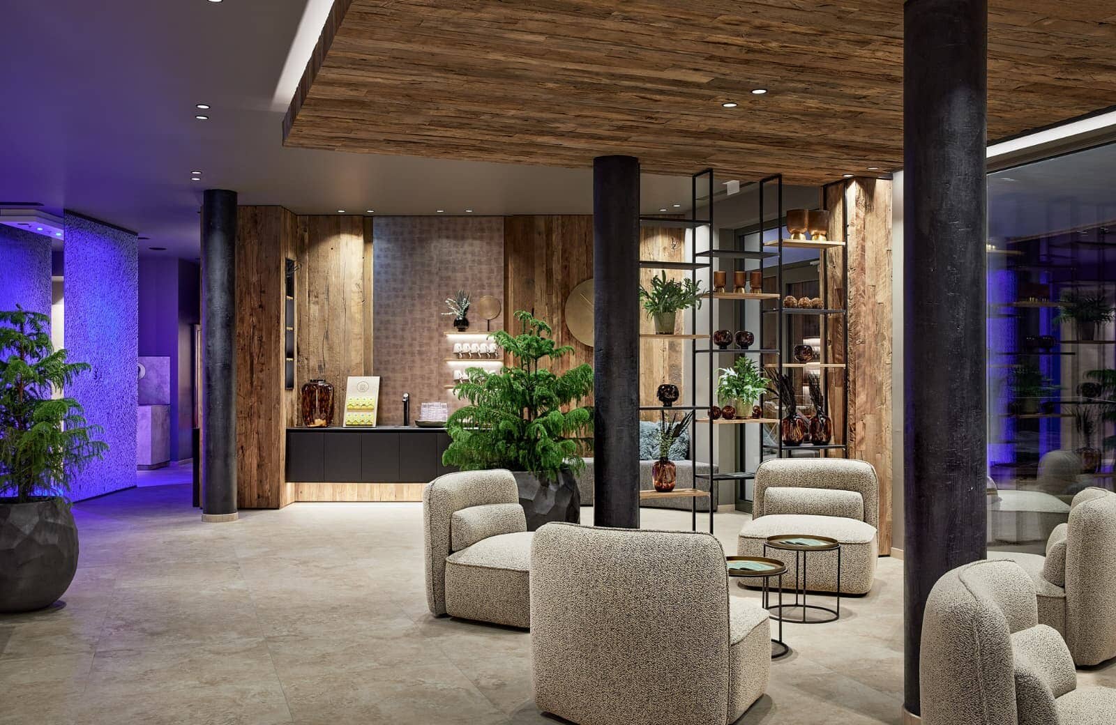Lobby lounge with coffee station, reclaimed wood accents, and armchair seating