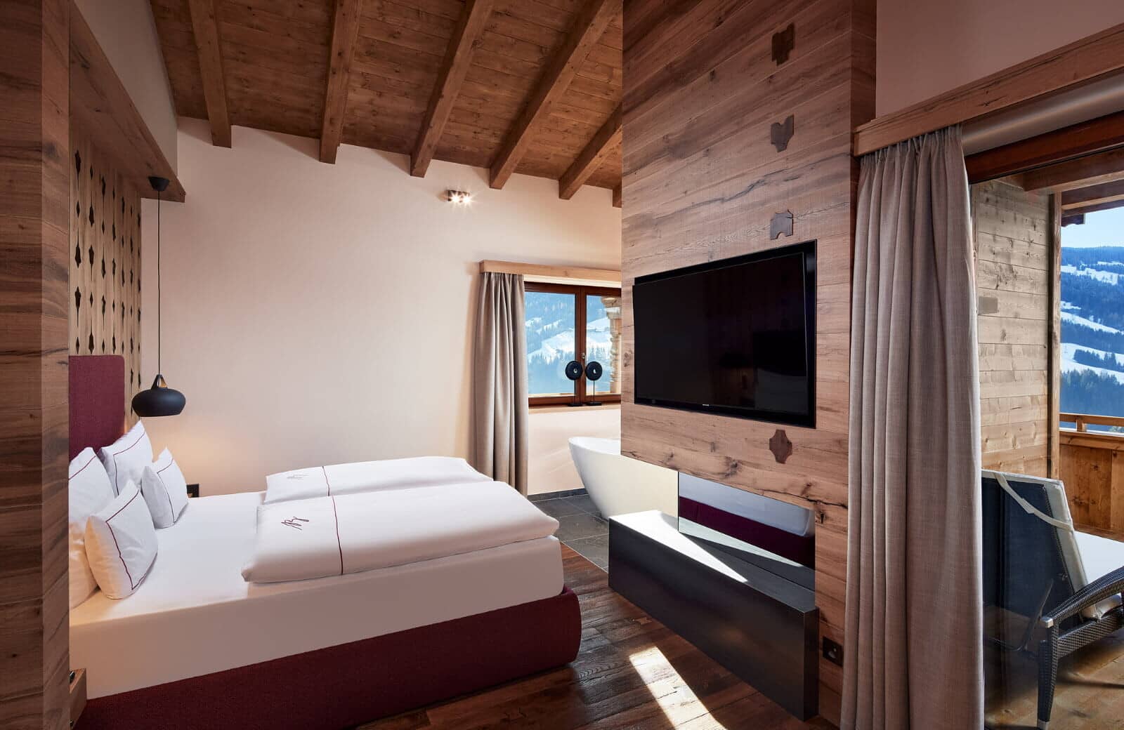 Primary bedroom with king bed, soaking tub, and balcony access