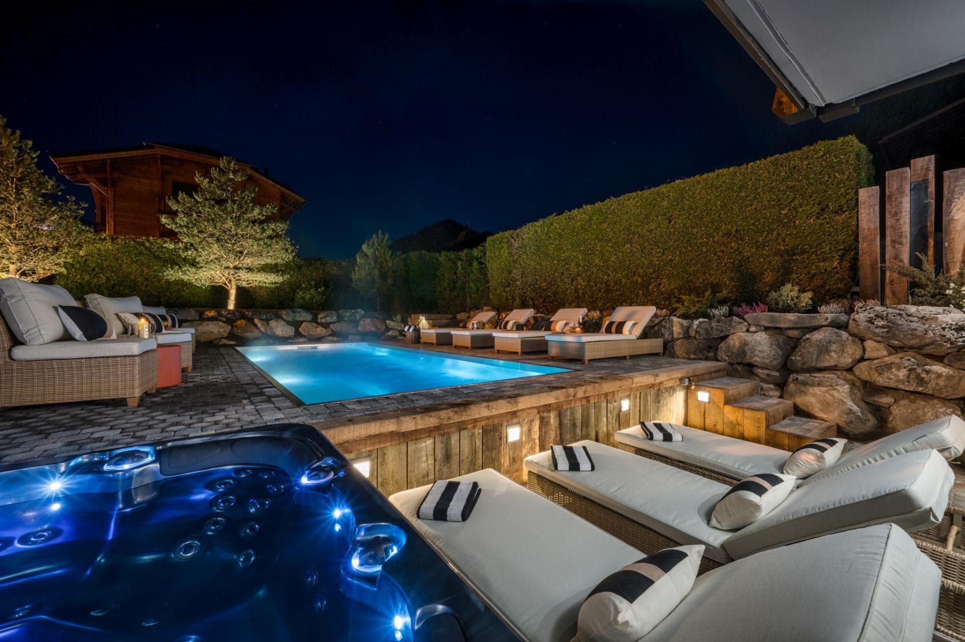 Heated outdoor pool and hot tub beside the chalet