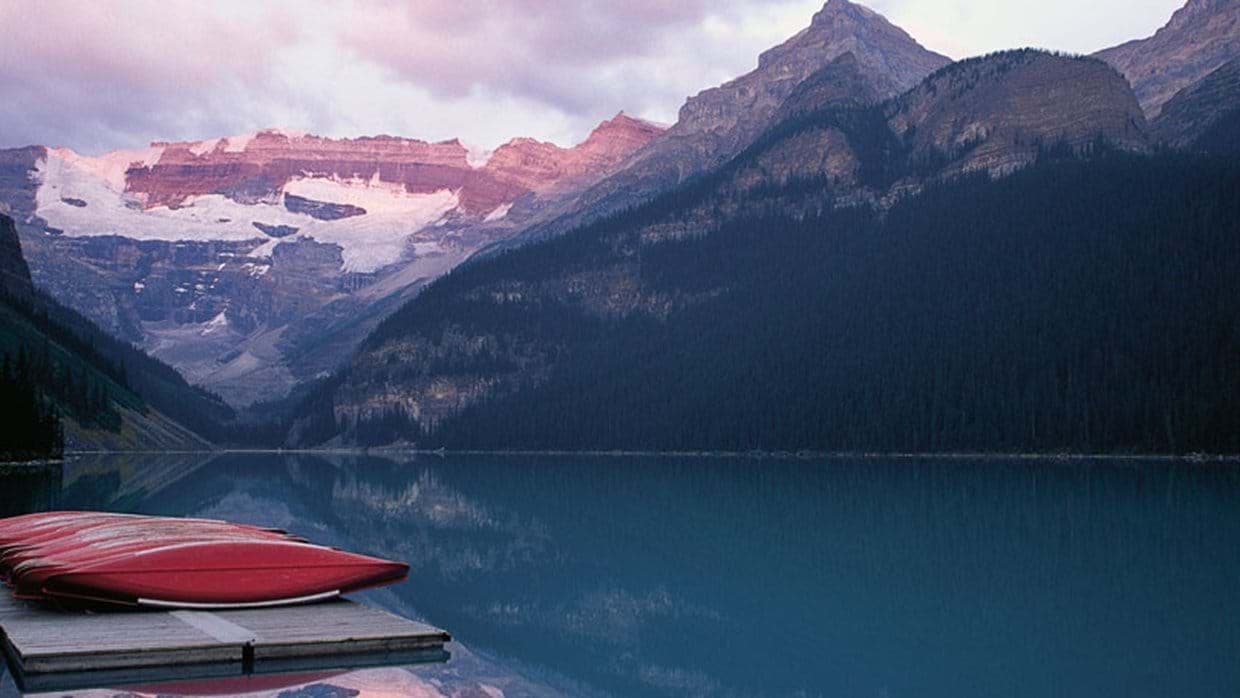 Lakefront view with private dock and red canoes for guest use