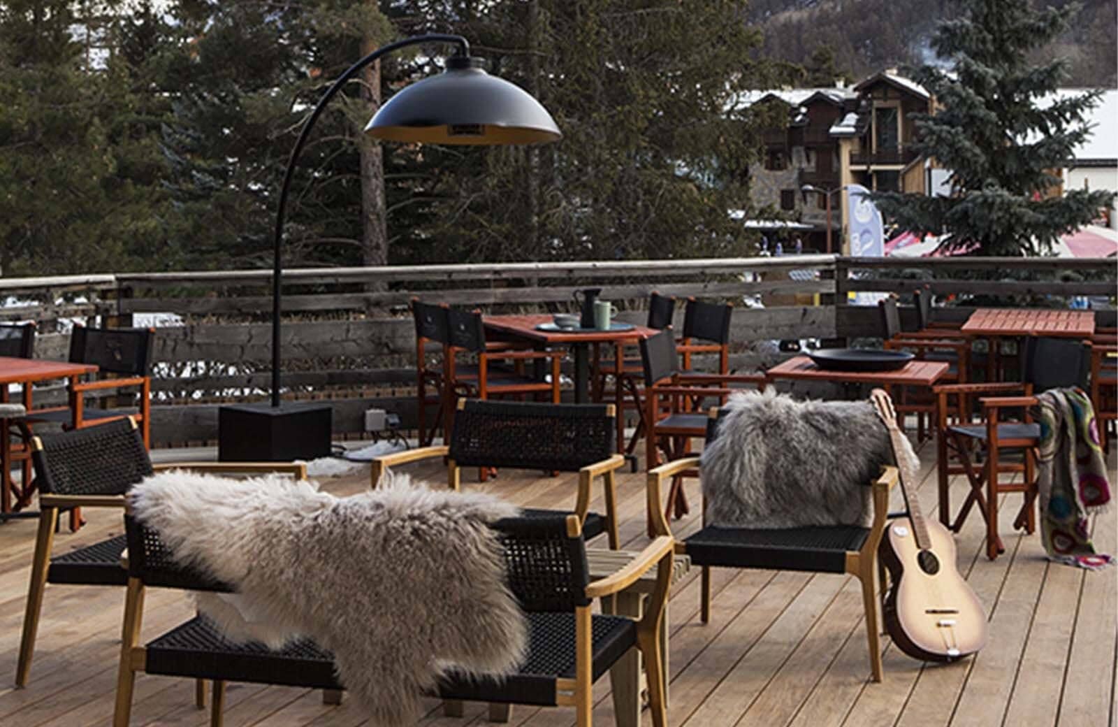 Outdoor terrace with heated seating and views of the ski village
