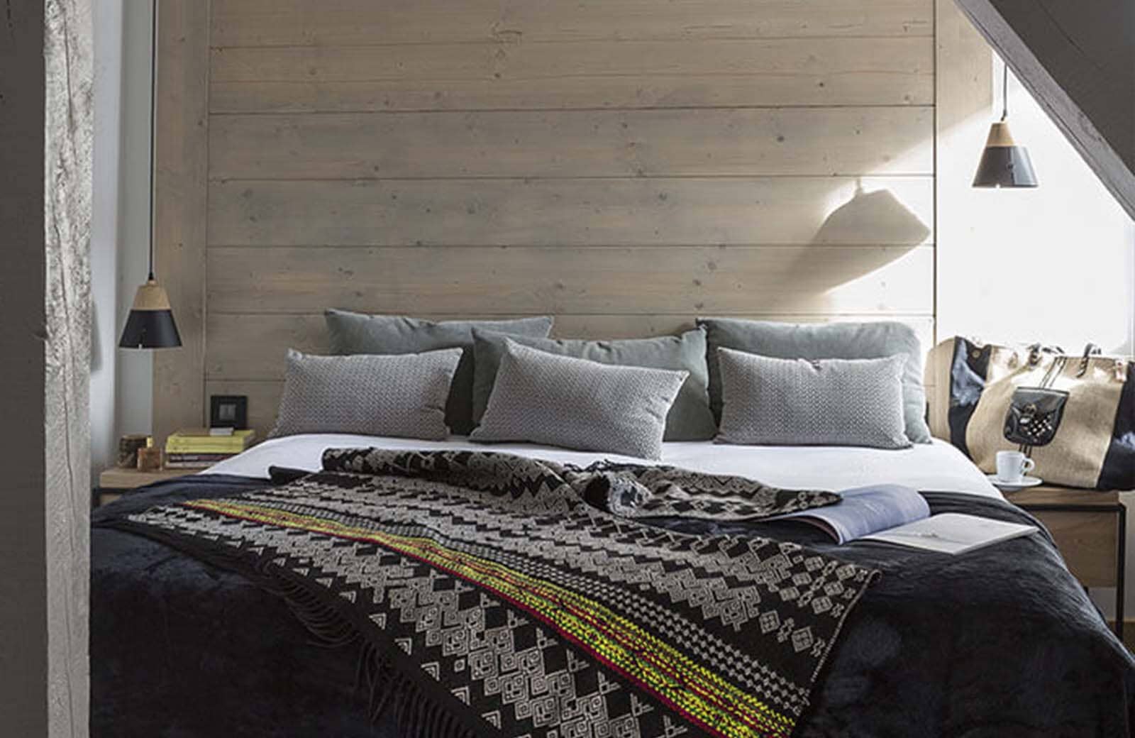 Attic bedroom with king bed and reclaimed wood accent wall