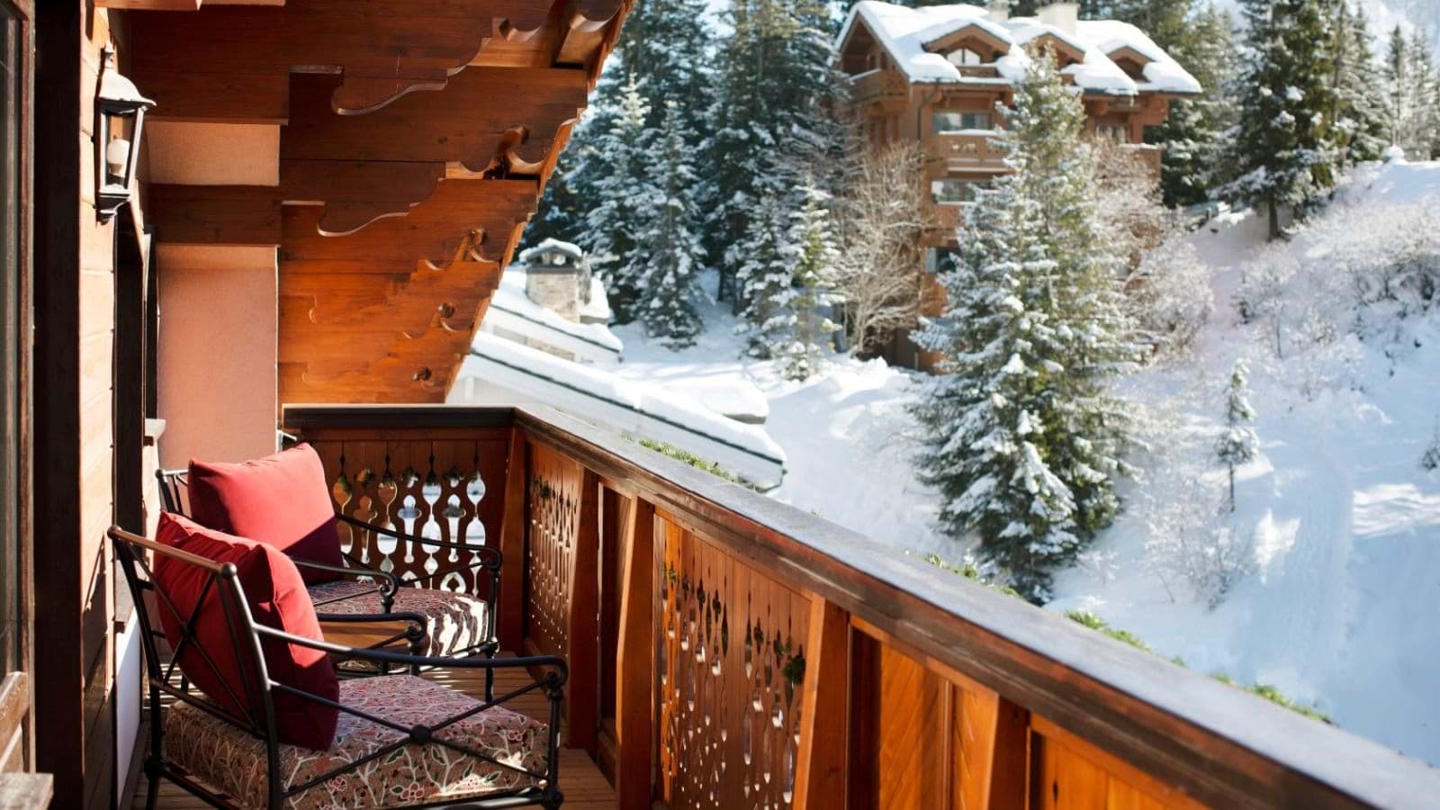 Private balcony with seating for two and snowy forest views