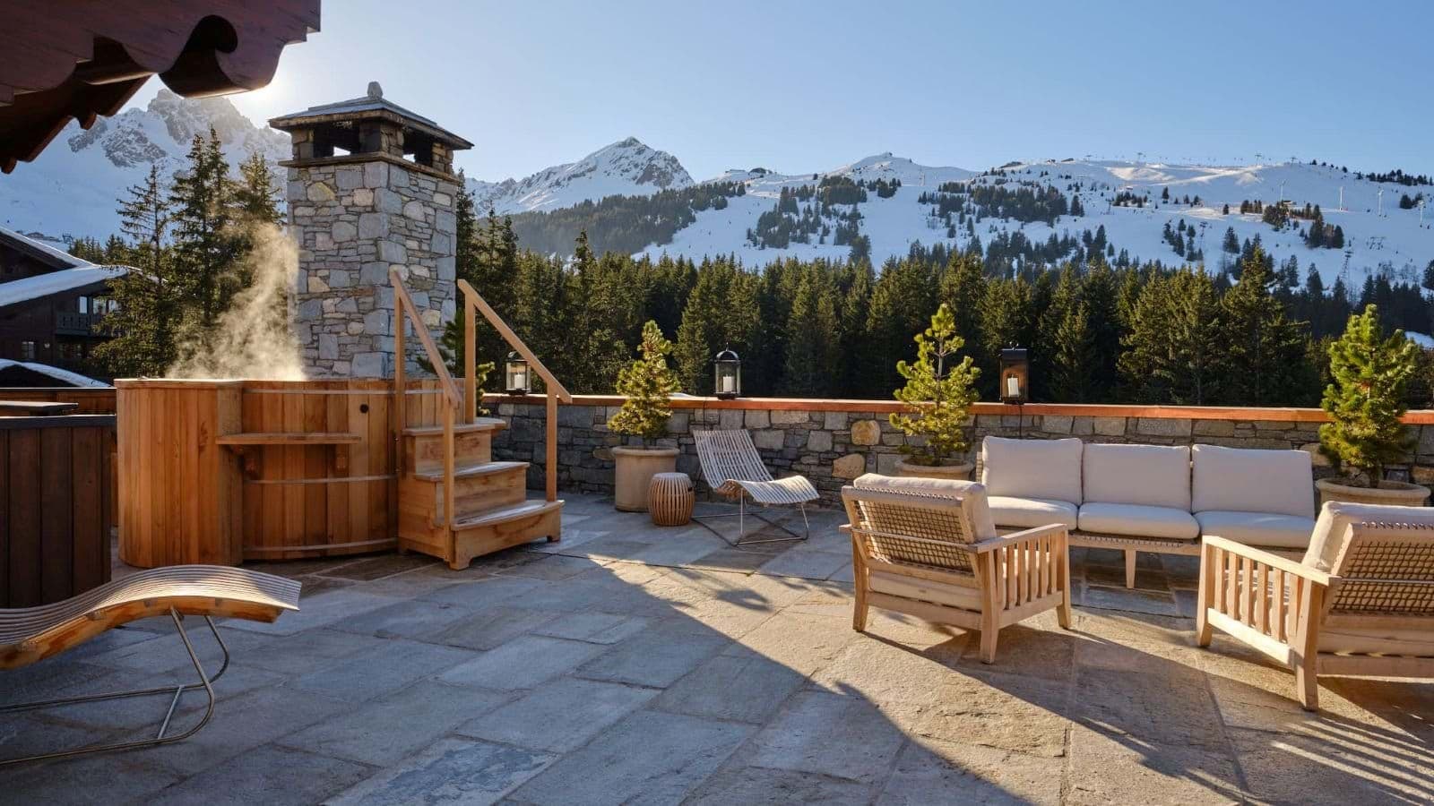 Stone terrace with cedar hot tub and mountain peak views