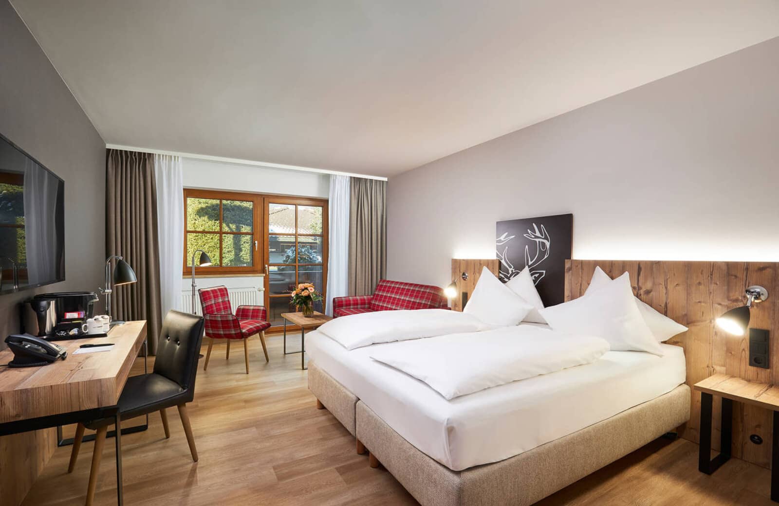 Bedroom with king bed, dedicated workspace, and access to private balcony