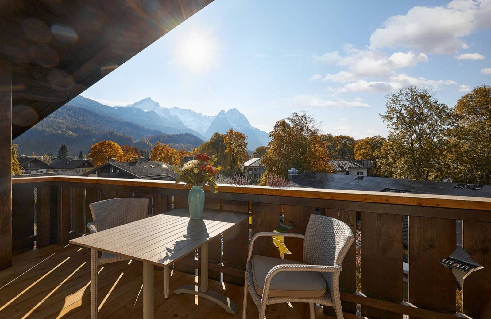 Covered balcony with seating for two and mountain views