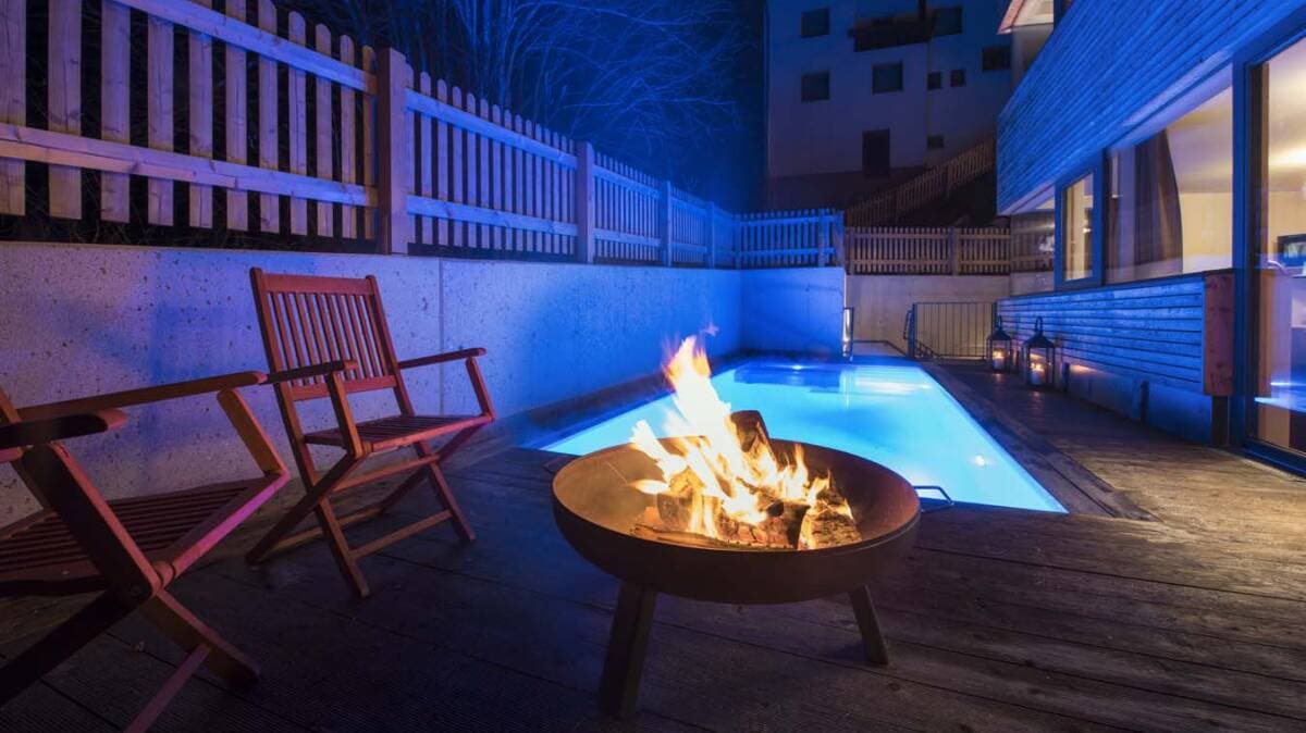 Rooftop deck with fire pit, heated pool, and lounge seating