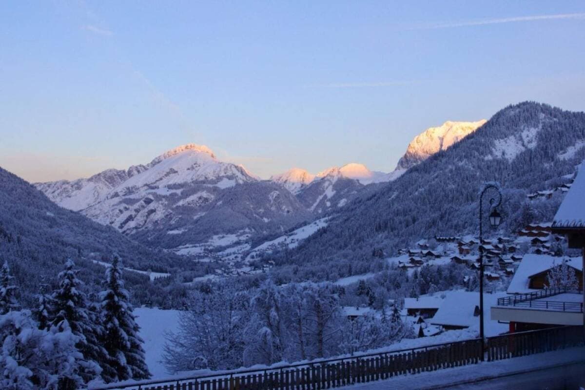 Sunrise alpenglow on snow-covered peaks; valley views from property deck