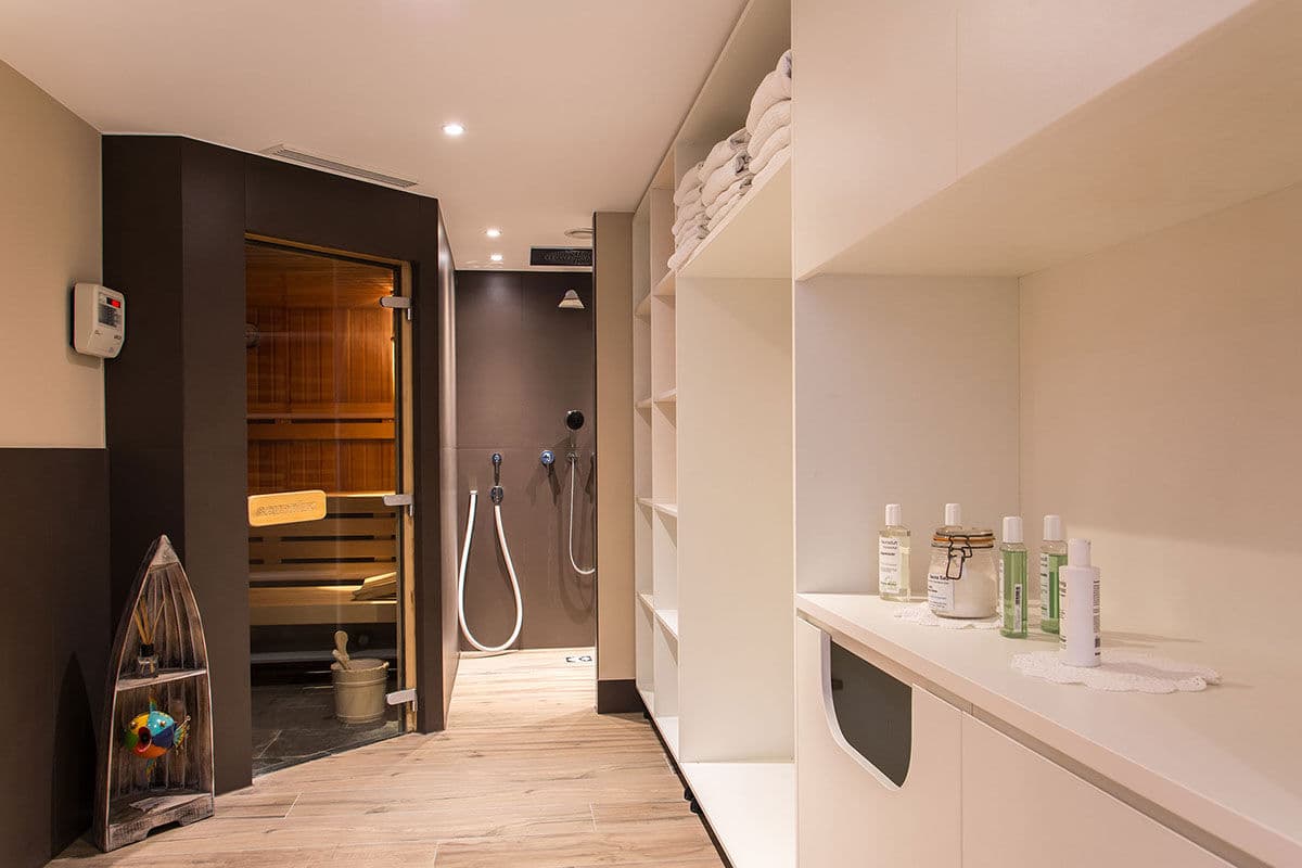 Spa bathroom with sauna, walk-in shower, and heated floors