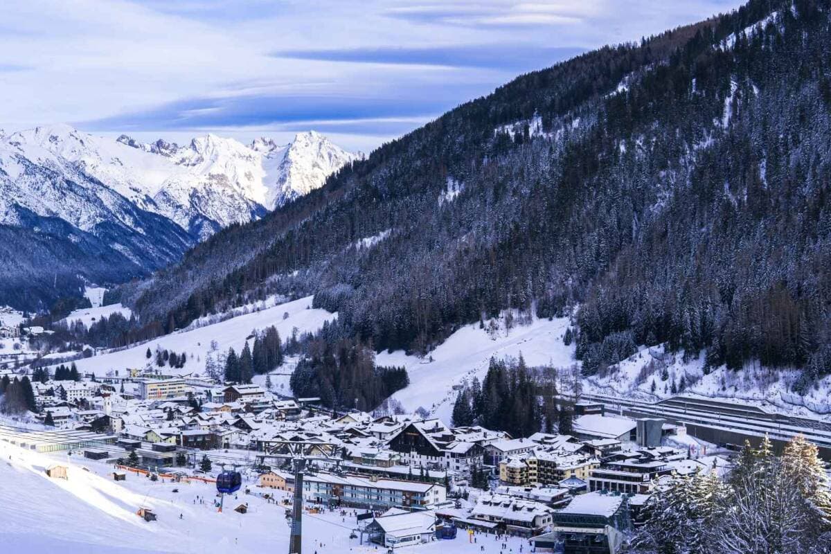 Ski resort village with valley views; lift access and alpine slopes visible