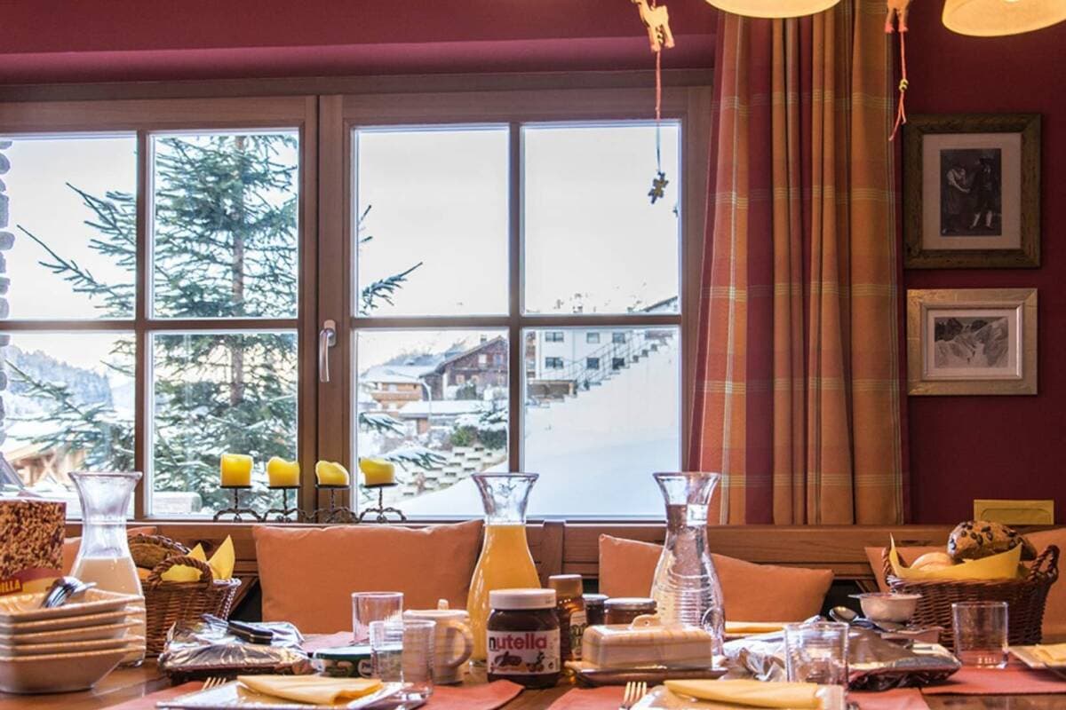 Dining area seats 8; alpine village and forest views through large windows